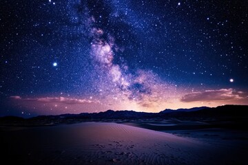 Starry night sky over sand dunes.