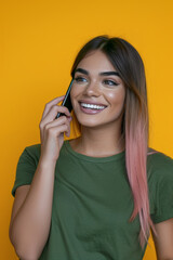 Fototapeta premium A woman is talking on a cell phone while smiling