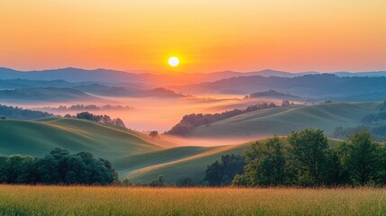 Fototapeta premium A scenic view of a sunrise behind rolling hills