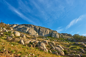 Rock, blue sky and landscape with mountain in nature for ecology, travel and growth. Habitat conservation, ecosystem preservation and biodiversity with sustainability and environment for ecotourism