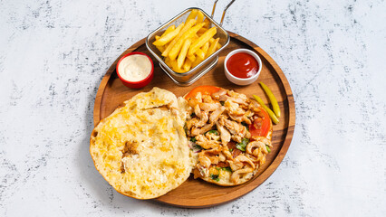 Delicious porion doner kebab with fries and vegetables