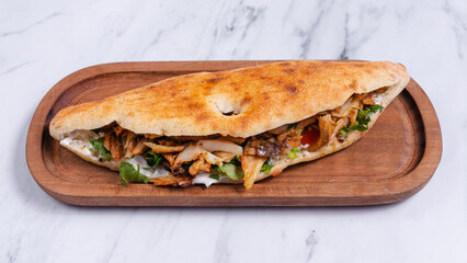 Delicious doner kebab on wooden tray