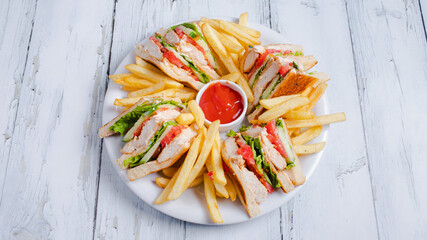 Sliced club sandwiches and fries