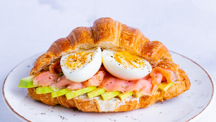 Salmon and egg croissant sandwich
