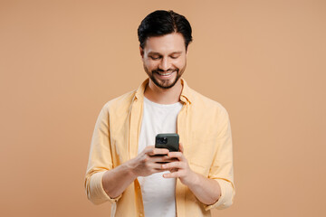 Happy young man reading good news on smartphone, social media, advertisement concept