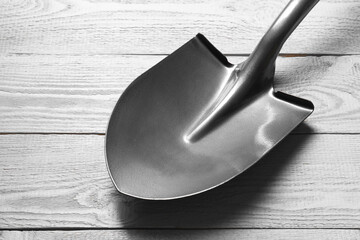 Metal shovel on light grey wooden table