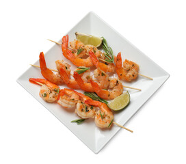 Skewers with delicious grilled shrimps and lime isolated on white, top view