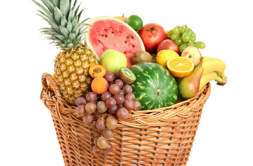 Many different fresh fruits in wicker basket isolated on white