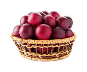 Fresh ripe plums in wicker bowl isolated on white