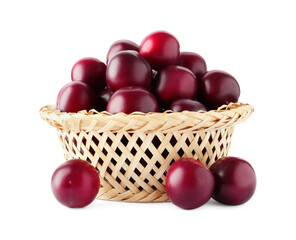 Fresh ripe plums in wicker bowl isolated on white