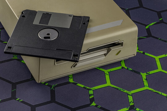 Disk drive from an old computer, colorful 3.5-inch floppy disks