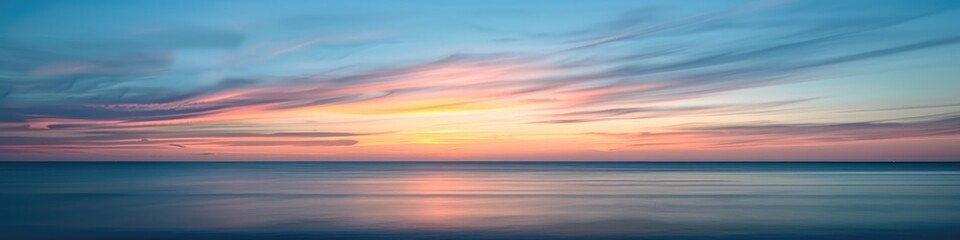 Tranquil coastal view during sunset featuring soft-hued skies and delicate clouds on the horizon.