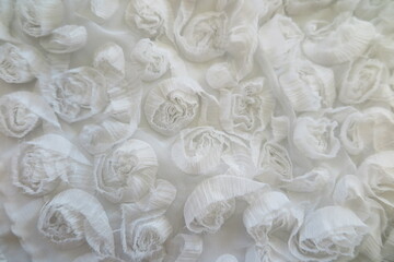 detail of a marble, fabric flowers, lace
