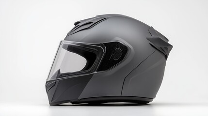 Gray motorcycle helmet isolated on white background. This helmet is designed to protect the head from impact in the event of a motorcycle accident. It has a hard outer shell made of fiberglass