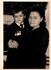 Retro portrait of a grandmother with her grandson. USSR, Ukraine, Dnepropetrovsk - circa 1972