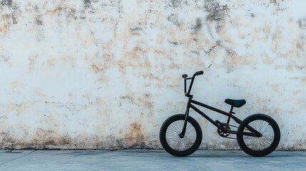 Black BMX Bike Against Textured Wall