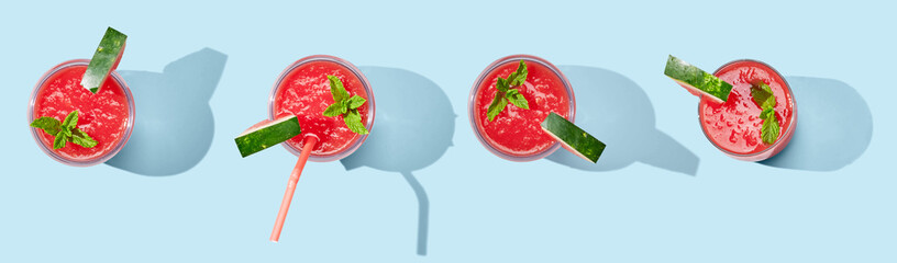 Strawberry smoothie in cup on blue pastel background