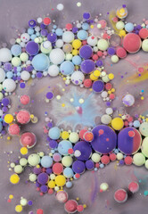 Colorful abstract art composition featuring vibrant spheres in a swirling pattern against a gray backdrop