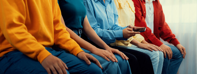 Group of interviewee candidate in colorful casual wear line up for interview sitting on the chair....