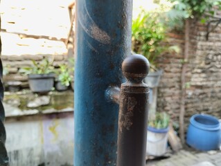 close up of blue iron paint peeling and rusty iron.