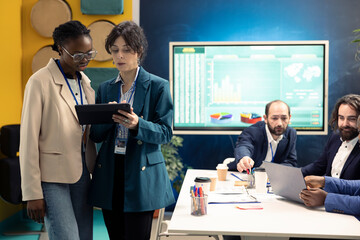Business colleagues examining success and efficiency metrics within the firm, presenting project insight. Employees evaluating statistics and data reports, team productivity and progress.