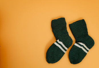 knitwear on yellow background. autumn outfit. autumn accessories. knitted hat and socks