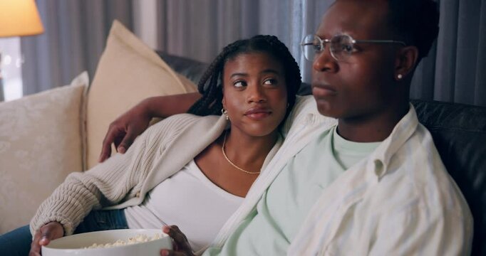 Home, relax and black couple with love, entertainment and watching tv in lounge. African man, woman and care with peace, comfort or hobby with movie, gratitude and series with relationship or break