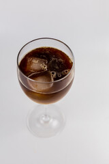 glass with cold iced coffee on a white background