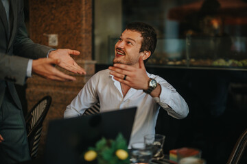 Colleagues discussing strategies in a meeting, focusing on sales and marketing growth. Energetic interaction and collaboration in a professional environment.