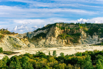 landscape of Plegrean volcano fields in Naples Italy near Pompeii with sulfur yellow caldera duribg eruption of smoke. campi Flegrei and cataclysm of Earthquake