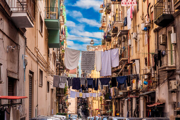 city view of old down town street of slum area with vintage facades of buildings and drying clothes...