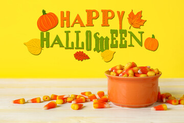 Halloween card with sweet corn candies on yellow background