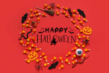 Halloween card with decorations and sweet corn candies on red background