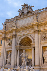 Obraz premium Fontana di Trevi, Rome at night, bathed in a mesmerizing glow. The grand baroque sculptures and the flowing water are dramatically illuminated, creating a stunning contrast against the deep, dark sky.