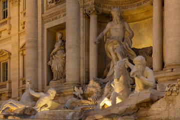 Fontana di Trevi, Rome at night, bathed in a mesmerizing glow. The grand baroque sculptures and the...