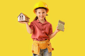 Cute little architect with house model and calculator on yellow background