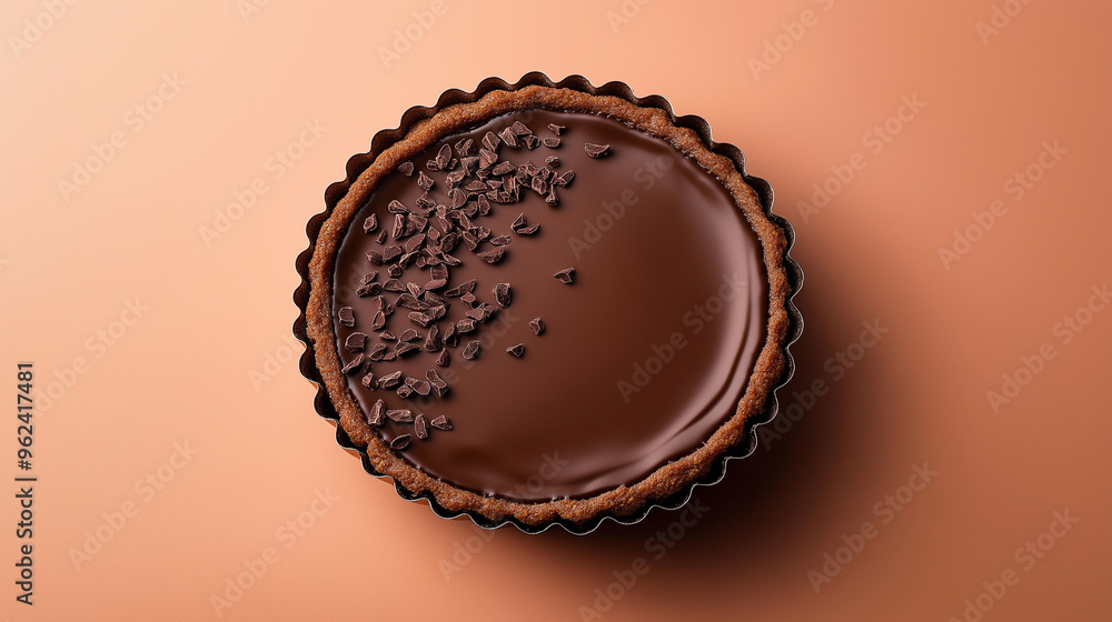 Wall mural a chocolate tart with a smooth ganache surface and a sprinkle of cocoa nibs against an isolated past