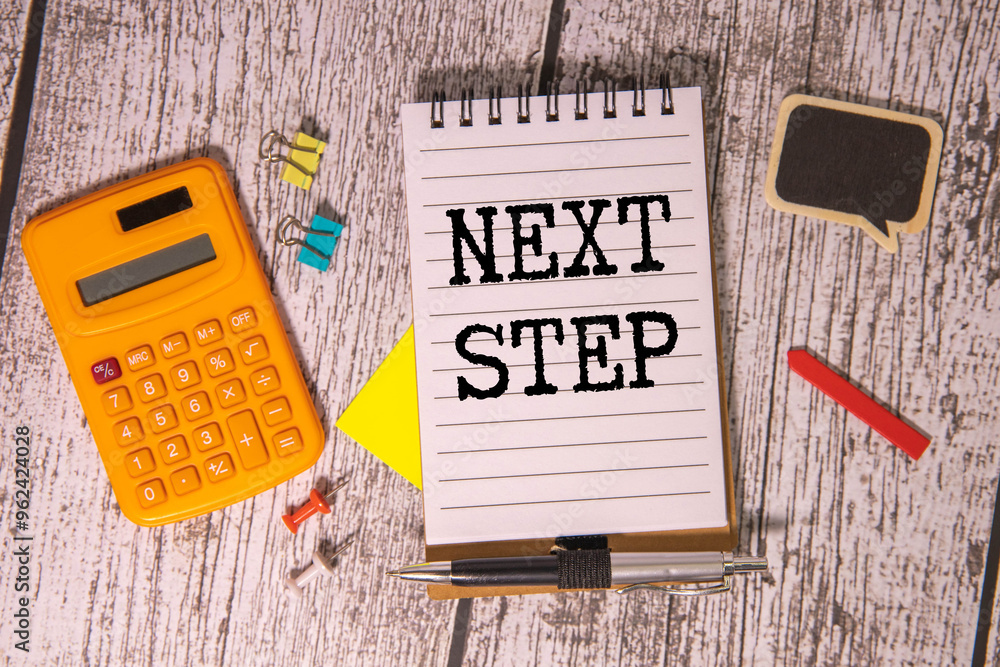 Aufkleber black marker over an open notebook with next steps text