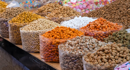 Traditional Moroccan snacks, nuts, candies and sweets at Souk el Had market in Agadir, Morocco. Assortment in oriental market