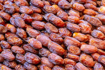 Dried dates at souk in Morocco. Pile of dates fruit at market stall filling all frame. Organic dried fruits as healthy alternative for sweets