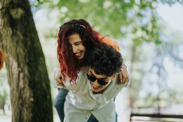 A joyful moment of young adults enjoying a sunny day in the park with laughter and fun piggyback...
