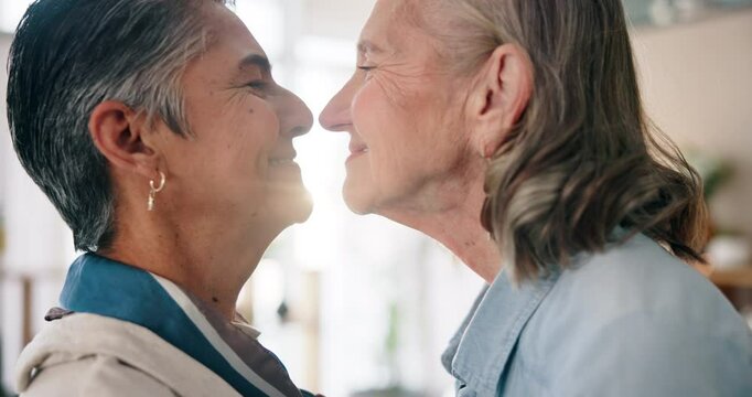 Happy, lesbian couple and nose touch for love, support or romantic connection in home. Smile, gay and mature women in relationship for commitment, lgbtq or eskimo kiss for care or loyalty in marriage