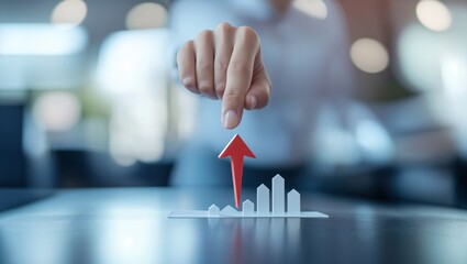A hand poised to elevate a red arrow above clear graphic bars symbolizes optimism in business trends, capturing a moment of financial growth and strategic decision-making.