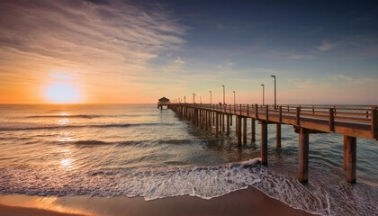 A Quiet Beach Pier Extending Into The Ocean At Sunrise, With Gentle Waves Crashing Against The Pillars..