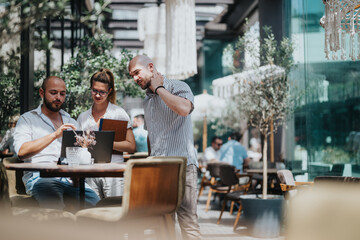 Business workers collaborating on a project in a relaxed outdoor coffee bar, brainstorming ideas and sharing knowledge for solutions while working remotely.