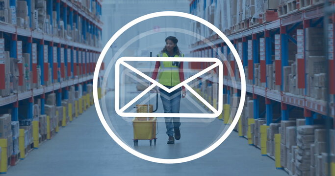 Image of envelope icon over biracial female worker in warehouse - Powered by Adobe