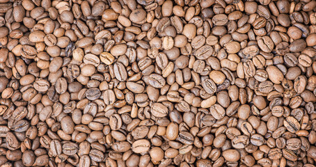 Roasted coffee beans as a background. Coffee, cheerfulness web size.