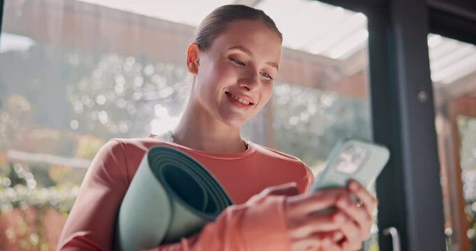 Happy woman, yoga and typing with phone for fitness, online browsing or health tips at home. Young, female person or yogi with smile on mobile smartphone for research, social media or exercise app