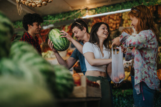 A group of friends happily selects fresh produce from a local greengrocer. The scene captures a lively, friendly atmosphere while shopping for fruits and vegetables.