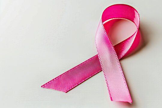 Magenta ribbon intertwined with pink flowers, set against a backdrop of white petals.	
